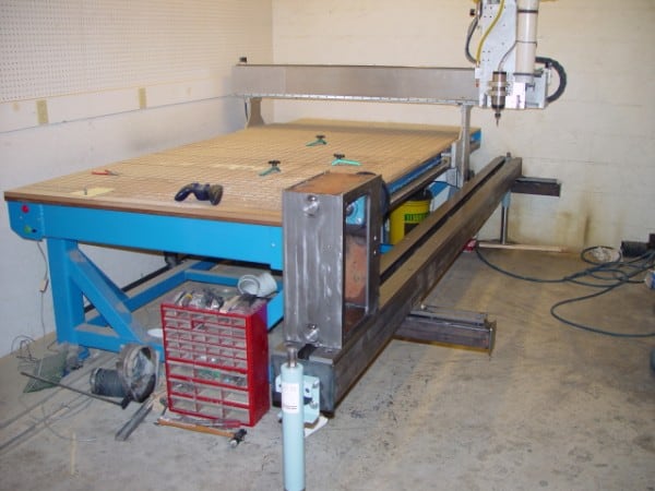 A woodworking workshop equipped with a CNC milling machine, including a 4th axis for enhanced precision and versatility.