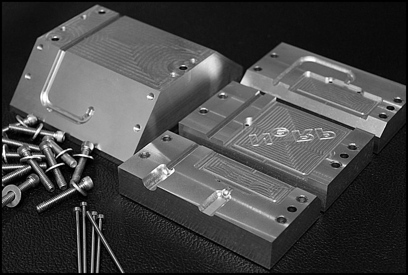 A black and white photo of a metal box with screws and bolts molding.