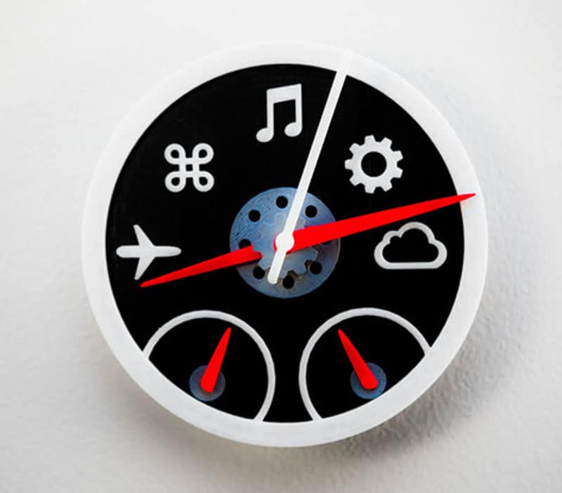 A 3D printed clock adorned with various icons.