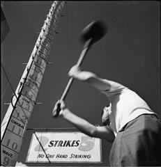 An old black and white photograph of a man swinging an ax, popular among Pro CNC'ers.