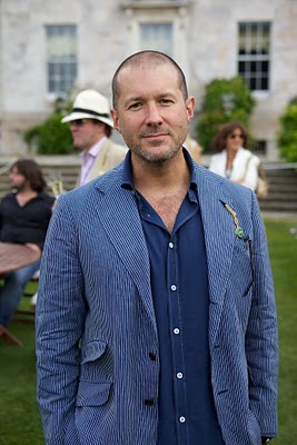 An individual in a suit addressing a gathering, demonstrating industrial design principles.