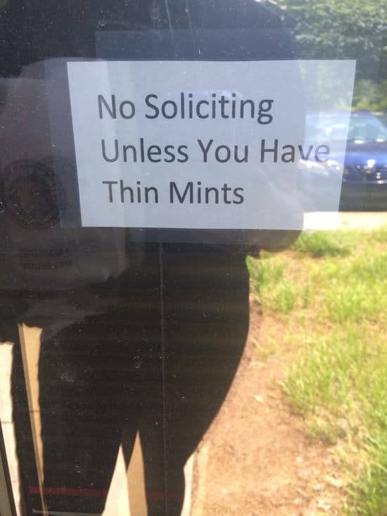 A sign that says no soliciting unless you're sharing thin mints.