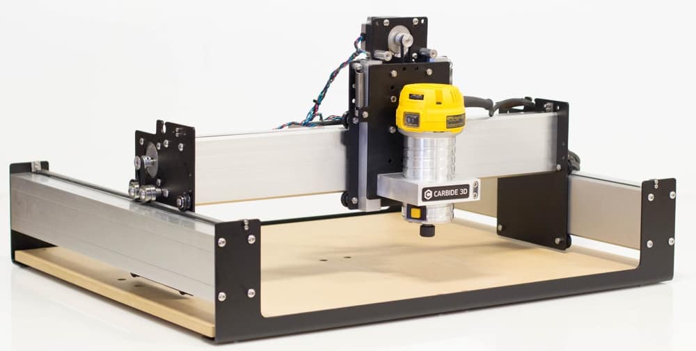 A desktop cnc milling machine with a yellow spindle mounted on a flat base, surrounded by metal frames.