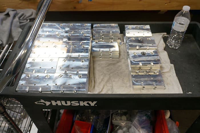 A black Husky tool cart with white "HUSKY" logo in an industrial setting.