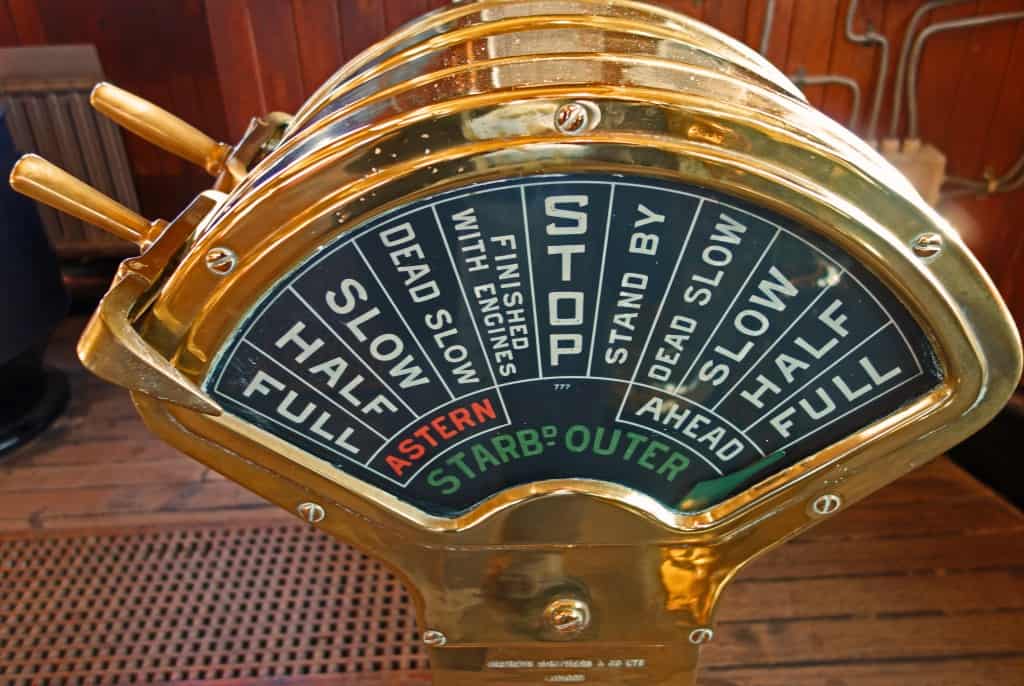 A large brass clock on a wooden floor, symbolizing the countdown to the New Year.