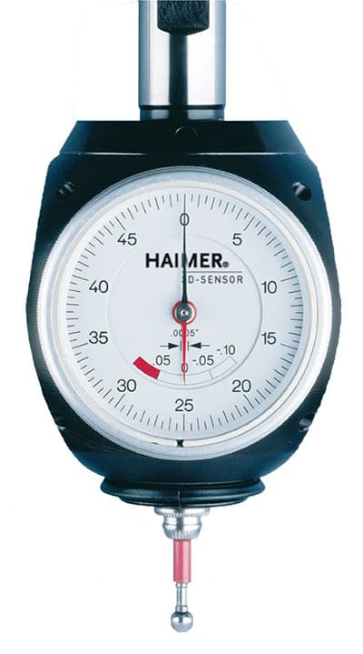 A Haimer dial gauge with a red pointer and black numbers on a white face.