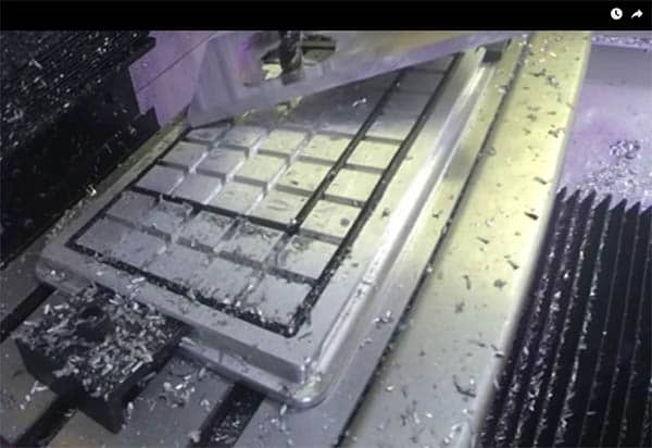 Metal workpiece on flat surface with scattered shavings.