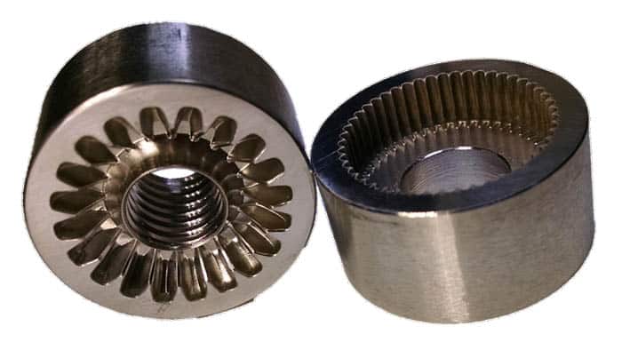 Two metal gears with beveled and straight edges against a light gray background.