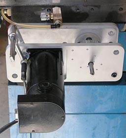 Metal component with a black cylindrical part, white plastic handle, and metal rod.
