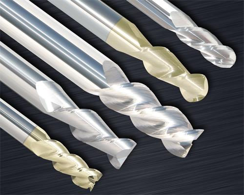 Three end mills with different cutting edges on a gray background.