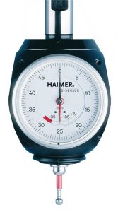 A dial indicator with a black plastic casing and white face.