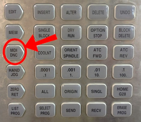 A close-up of a control panel with MDI DNC button.