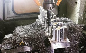 Metalworking machine shop with machinery and tools on a workshop floor.