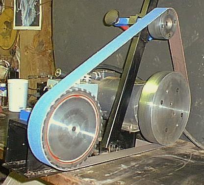 Industrial belt-driven machine with blue belt, metal pulley, and black stand.