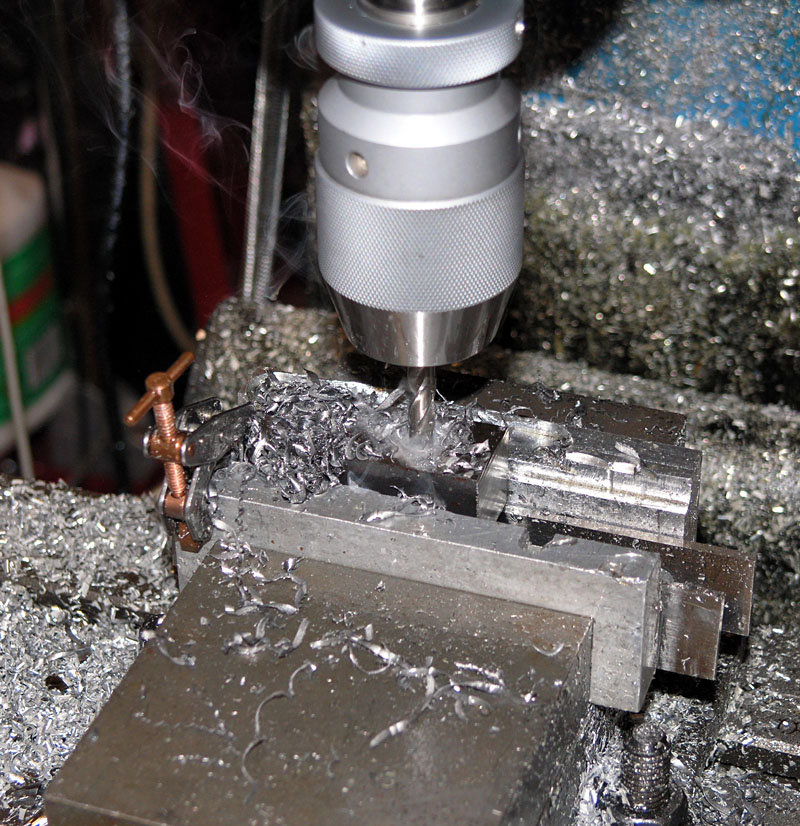 Drill bit in use on metalwork.