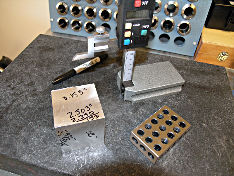 Precision machining tools: calipers, micrometers, and measured metal blocks.