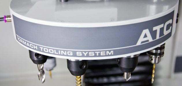 A Tormach ATC machine tool with the brand name "TORMACH TOOLING SYSTEM" displayed.
