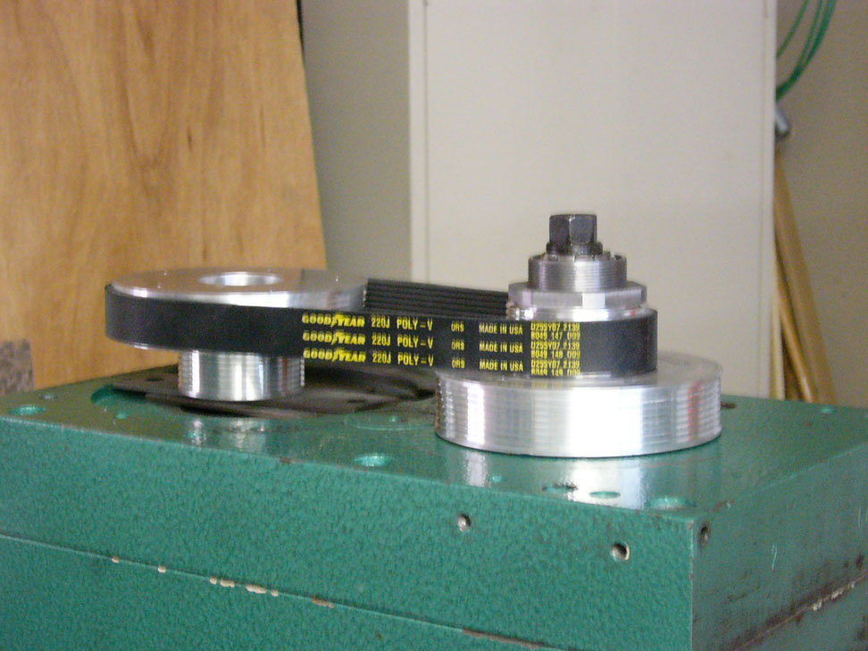 Circular metal pieces with black bands and a cylindrical object with yellow text.