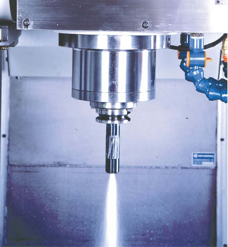 A stainless steel component featuring a cylindrical body with a long nozzle emitting a stream of coolant fluid.