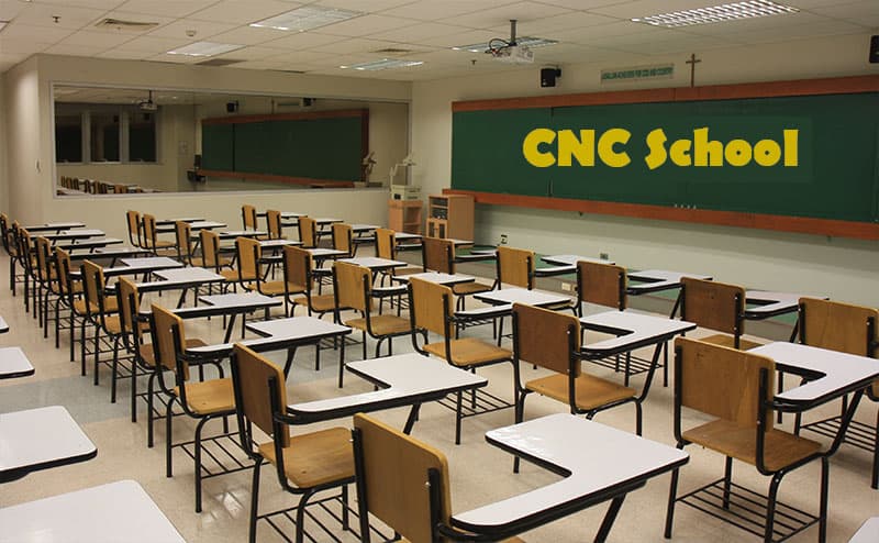 A classroom full of desks and chairs where students learn CNC basics at the CNC School.