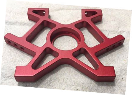 A red aluminum frame part for a rc car.