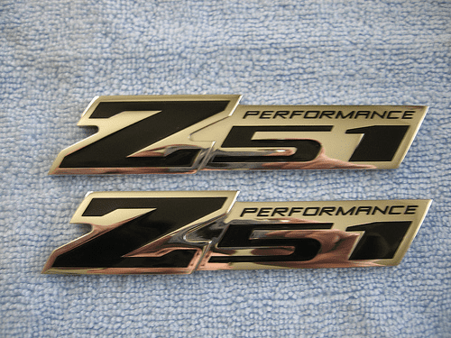 Two black and gold z51 performance badges on a towel with high-speed attachments.