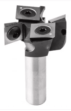 Black and white image of a metallic object with cylindrical base and two square protrusions topped with round holes.