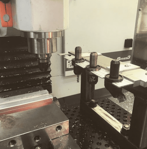Metalworking machine spindle with tool mounts and cylindrical attachment.