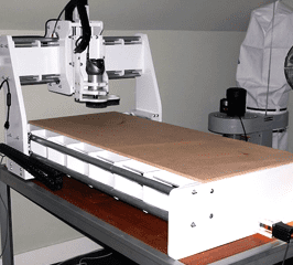 A rectangular wooden worktable with various machining tools and equipment arranged on its surface.
