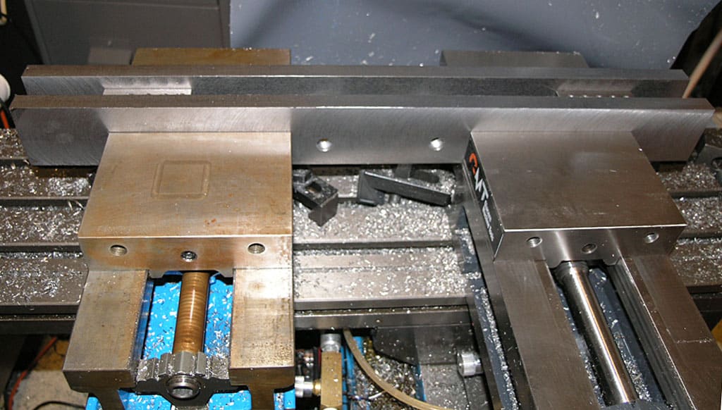Heavy-duty vise on milling machine table.