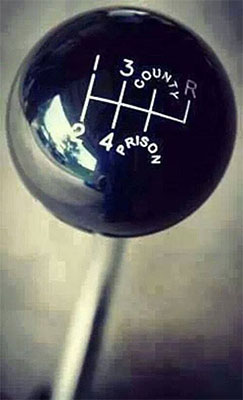 A picture of a shift knob with the word country on it, showcasing fine adjustments.