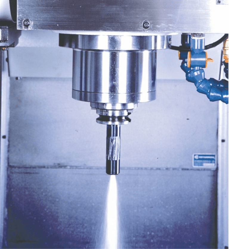 Metal cutting tool in action on industrial machine with sparks.