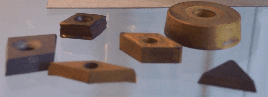 A collection of carbide cutting tools displayed on a table.