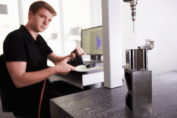 A CNC programmer working on a machine.