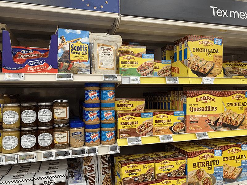 Grocery store shelf stocked with packaged food items.