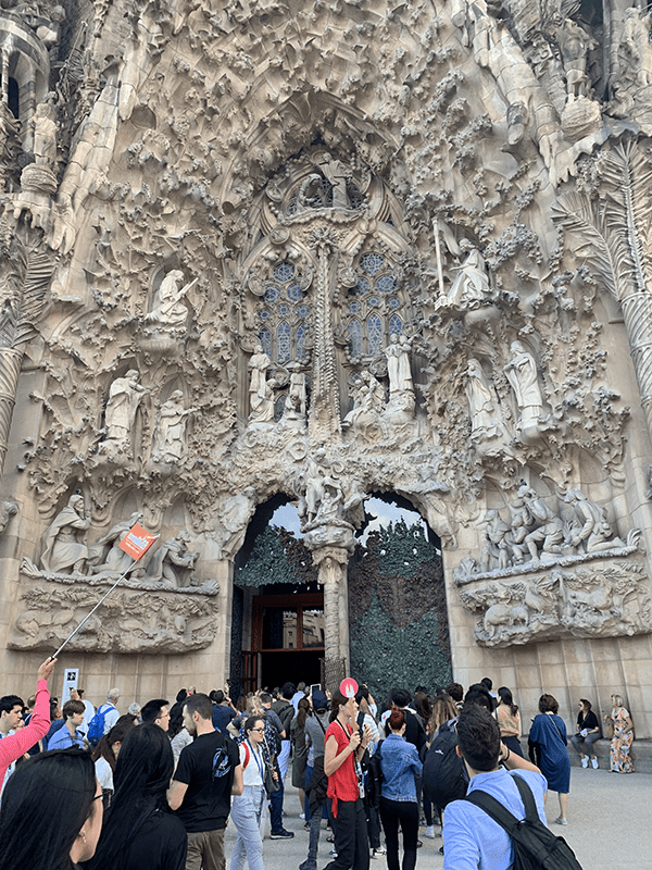 Large stone building with intricate carvings and sculptures on facade.