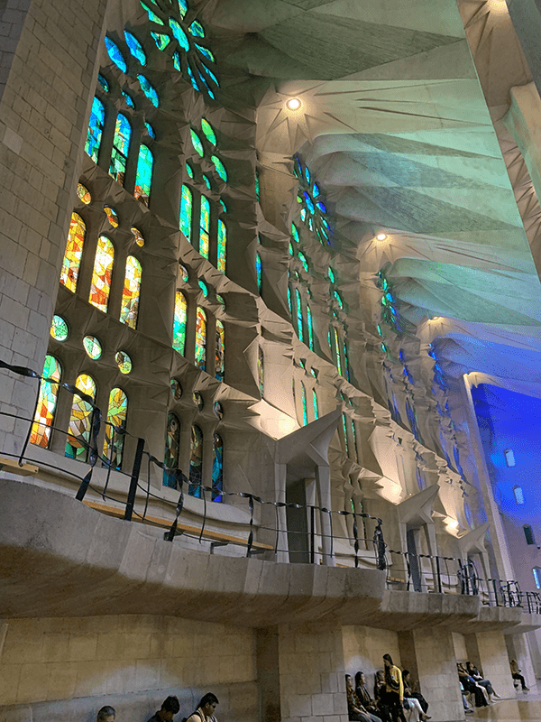 Large stone building with vibrant stained glass windows.