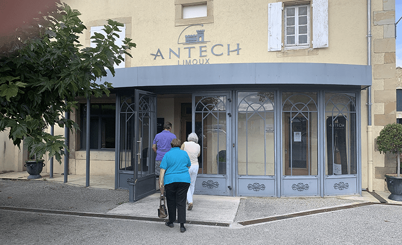 A photograph of Antech Limoux building with people walking toward the entrance.