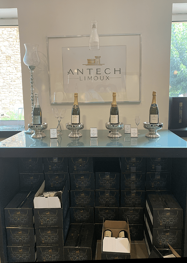 Wine tasting display with sign reading Antech Limoux