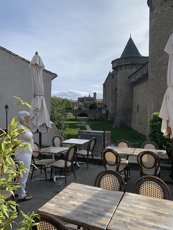 Serene outdoor setting with stone walls and lush greenery.