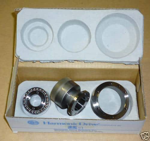 A box containing a set of bearings and a ring, suitable for 4-axis CNC operations.