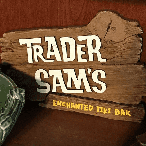Rustic wooden sign with "TRADER SAM'S ENCHANTED TIKI BAR" in bold white letters.