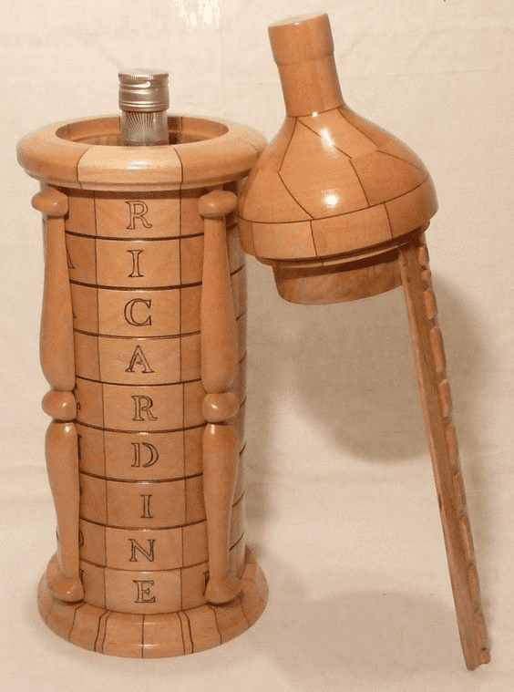 Wooden bottle-shaped object with "RICARDINE" engraving.