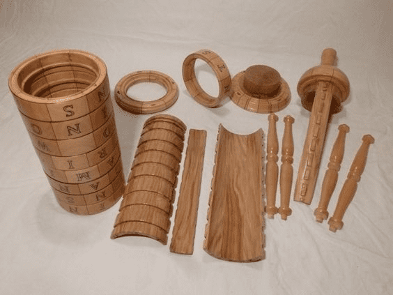 Wooden machined components with engraved letters and numbers.