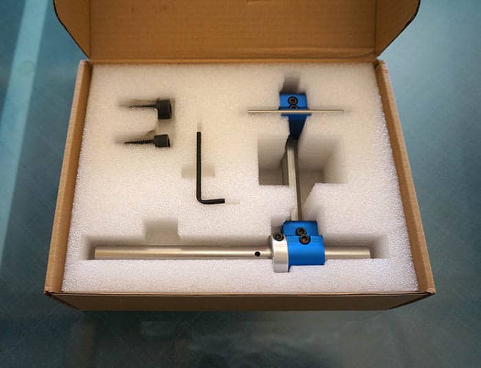 A machinist vise with a blue tool in it.