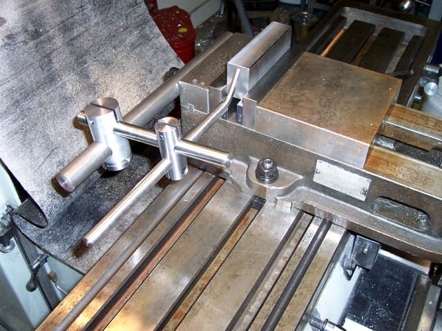 Metal vise with stop block, showcasing robust design and functionality.