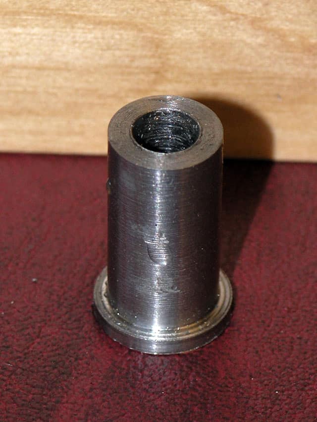 Cylindrical metal object with threaded central hole.