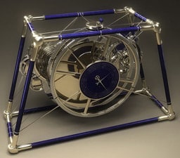 A mini clock with a blue and silver frame.