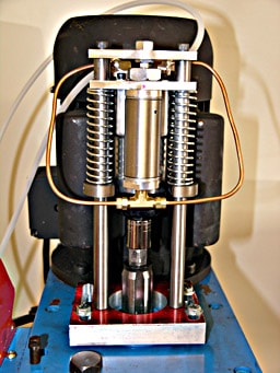 Silver drawbar with copper wires on a CNC milling machine.