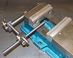 A photograph of a vise with two stops on the jaws.